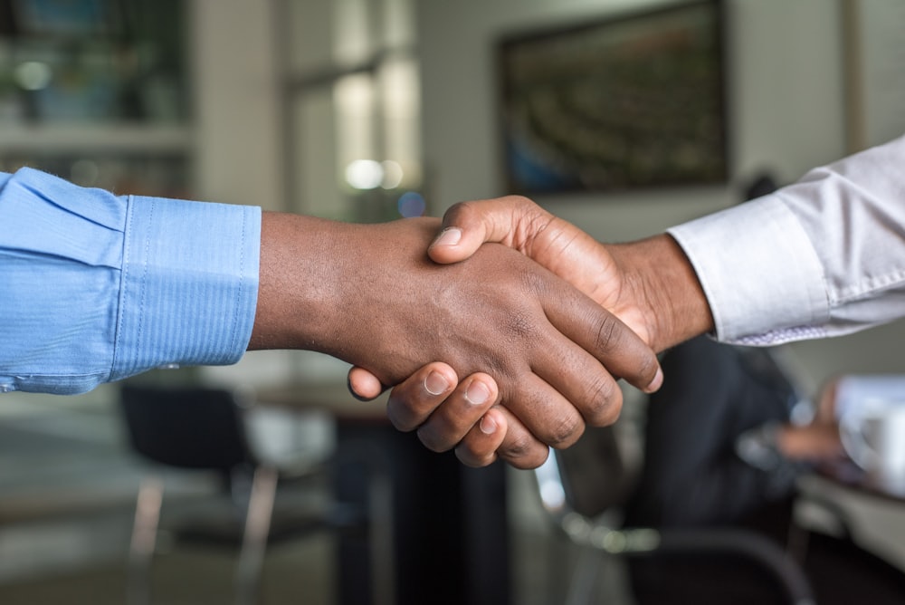 Business handshake formalizing a remote staffing partnership